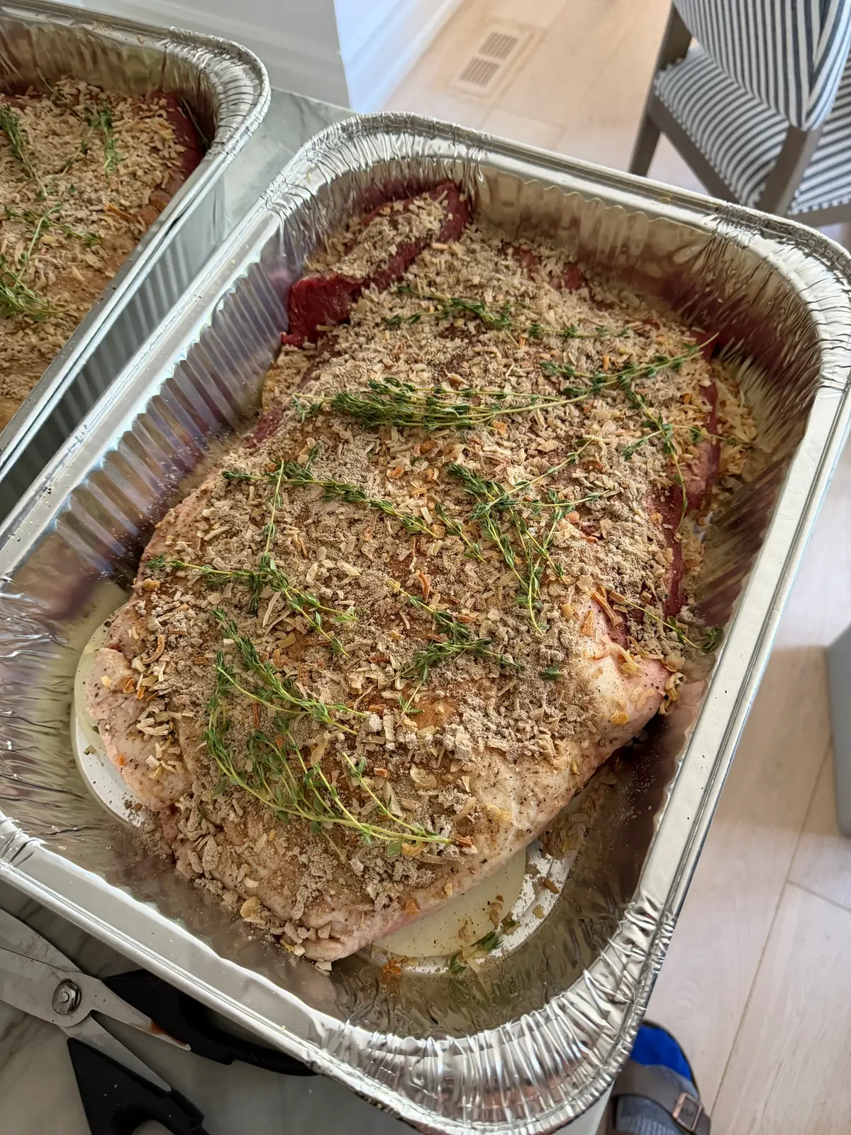 Step 3. The brisket topped with onion soup mix, garlic, pepper and thyme sprigs